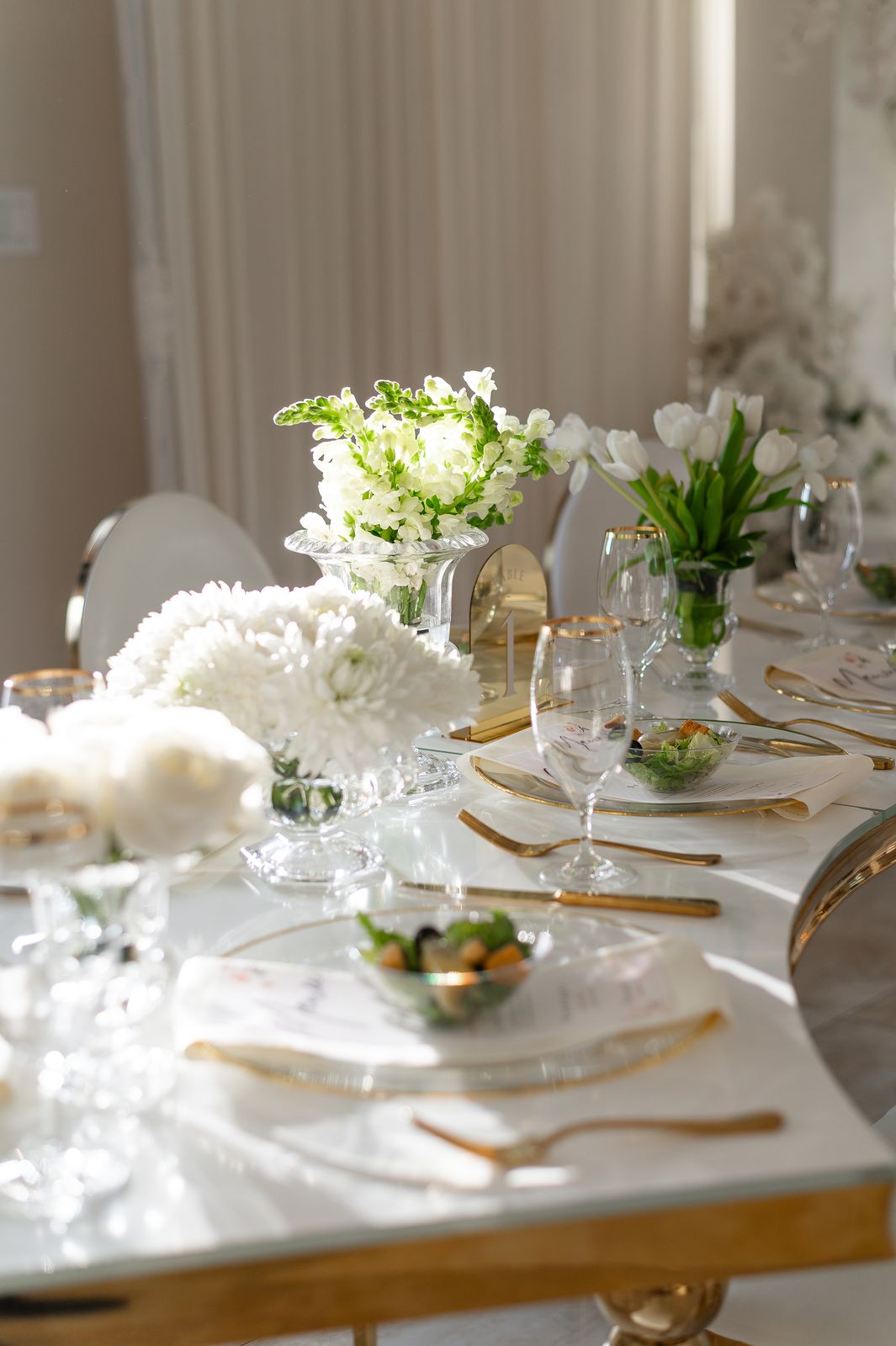 Small event table with blush peony centerpiece and taper candles